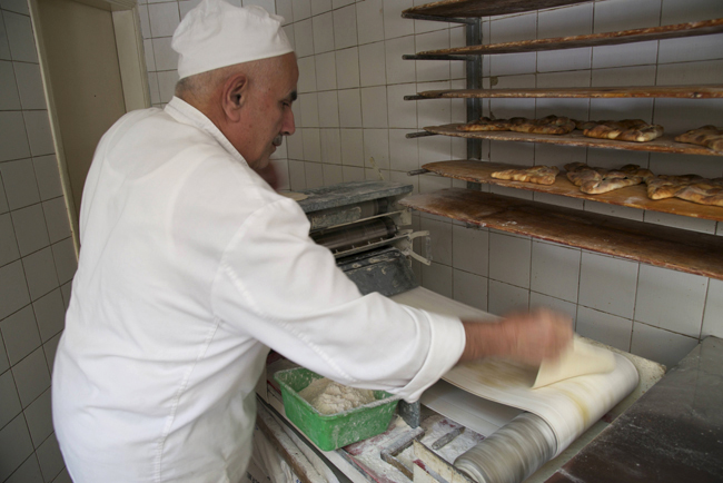 l-emile's bakery-rolling out dough for manaqish copy